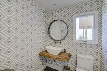 Mt Tam view bathroom, patterned wallpaper, sink, and mirror